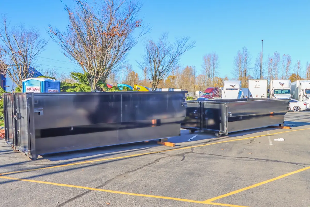Professional dumpster rental service with roll-off container on residential driveway in Stockton